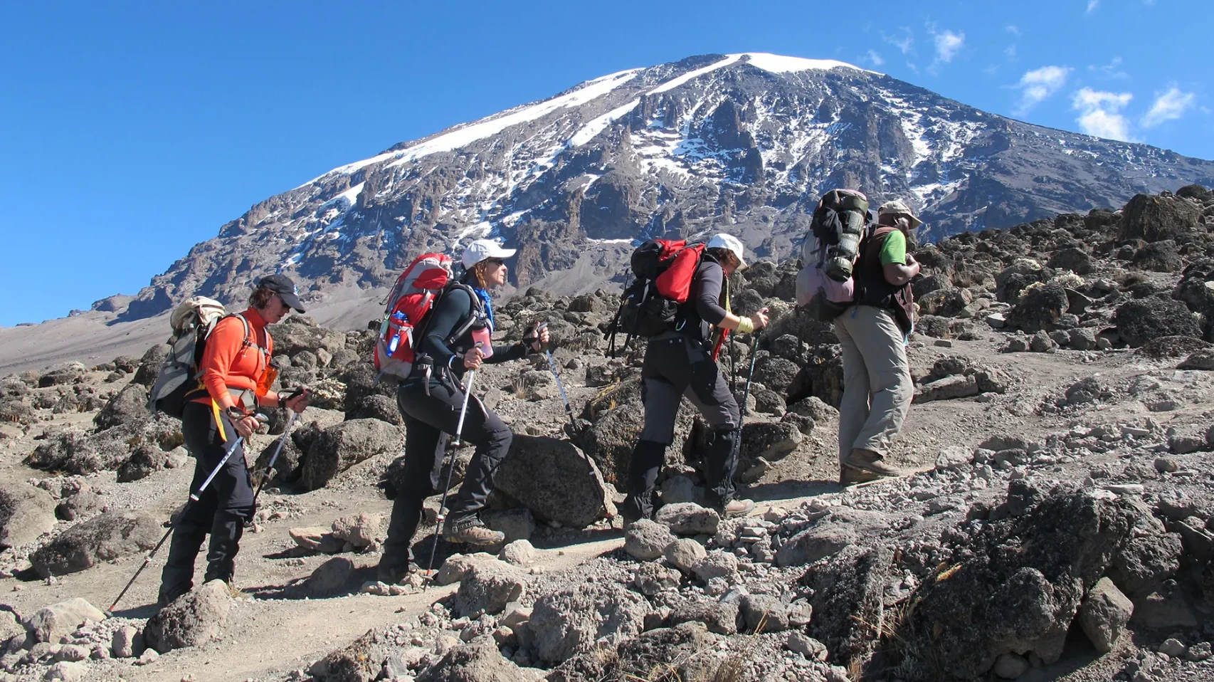 Kilimanjaro climbers acclimatizing on the mountain with wide glacial landscape visible above 4,500m