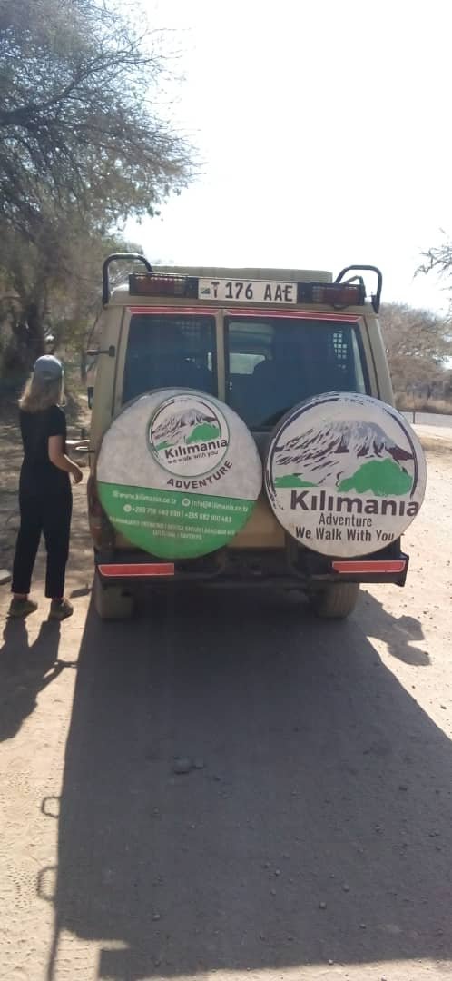 Kilimania safari Land Cruiser on a dry dirt track, showing the vehicle travellers spend most of a crater day in