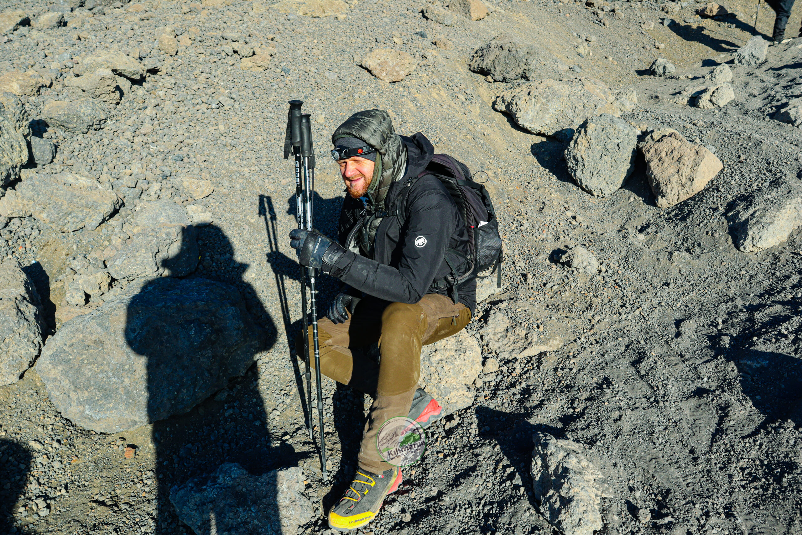 Climbing Kilimanjaro With Medical Conditions Climber resting during a high-altitude ascent on Mount Kilimanjaro
