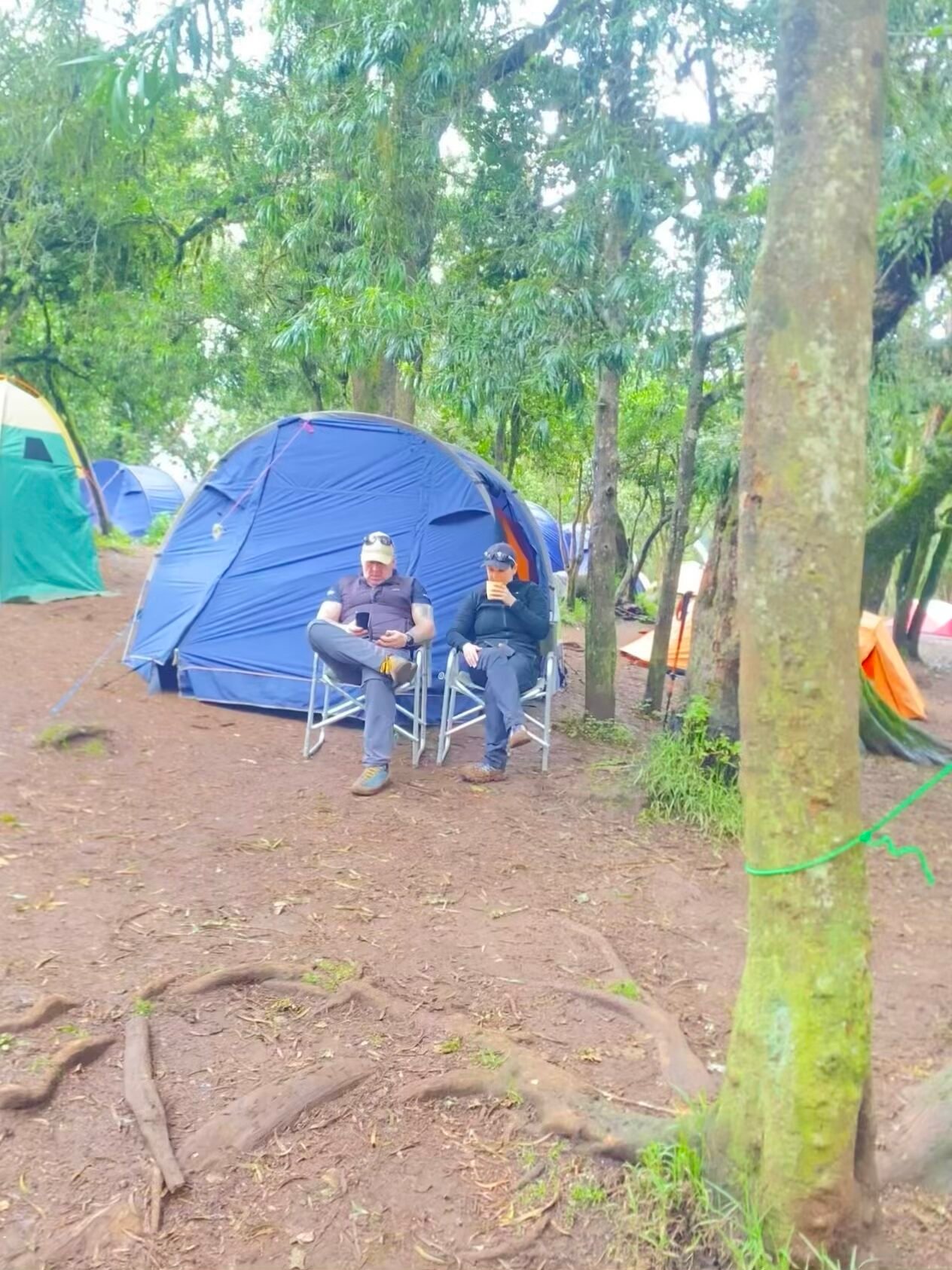 Kilimanjaro climbing gear including sleeping bag and layers laid out before a Kilimania Adventure expedition — gear check in Moshi