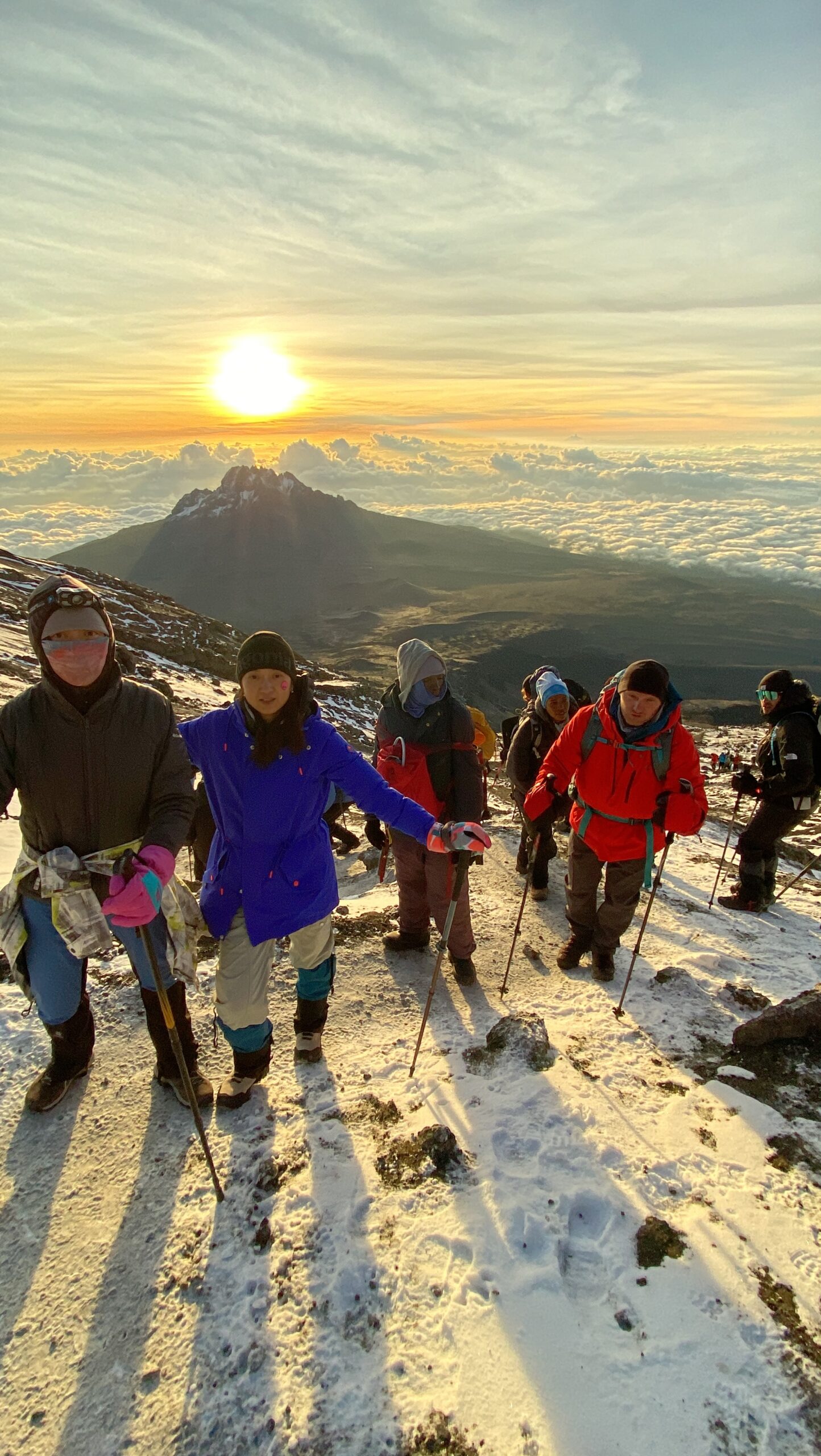 Marangu Route Kilimanjaro: Honest Success Rates, Day-by-Day Guide, and Who Should Choose It | Kilimania Adventure Kilimania Adventure climbers making the final push to Uhuru Peak at sunrise above Gilman's Point on the Marangu Route, Mount Kilimanjaro, Tanzania.