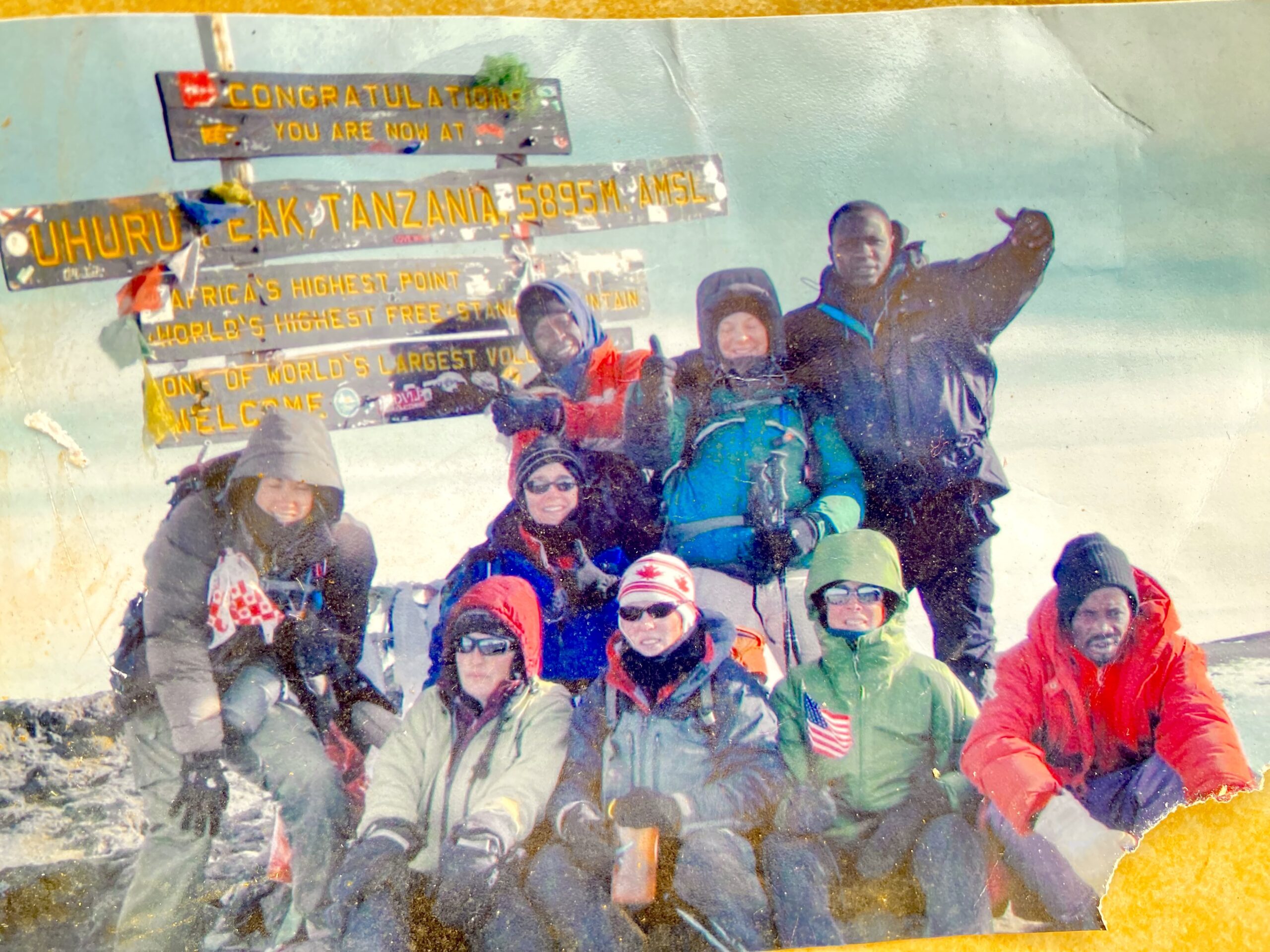 Senior Kilimanjaro Guide Historic photo of Sabinus Msimba with American and Canadian climbers at Uhuru Peak on Mount Kilimanjaro