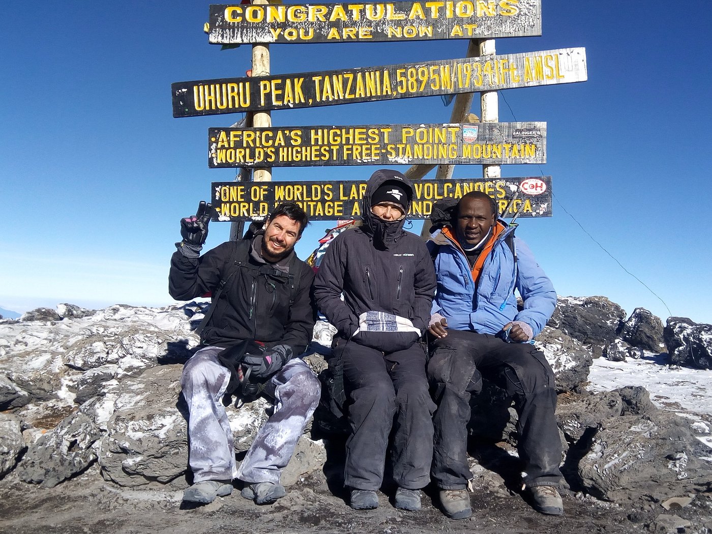 Sabinus Msimba: Senior Kilimanjaro Guide With 22 Years of Experience on Mount Kilimanjaro | Kilimania Adventure Senior Kilimanjaro guide Sabinus Msimba (right) and climbers at Uhuru Peak, Africa's highest point at 5,895 metres on Mount Kilimanjaro, Tanzania. Worst Part of Climbing Kilimanjaro