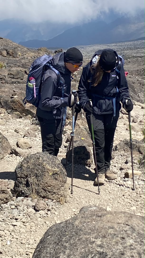 A mother and daughter trekking across the Shira Plateau between Shira 1 and Shira 2 Camps