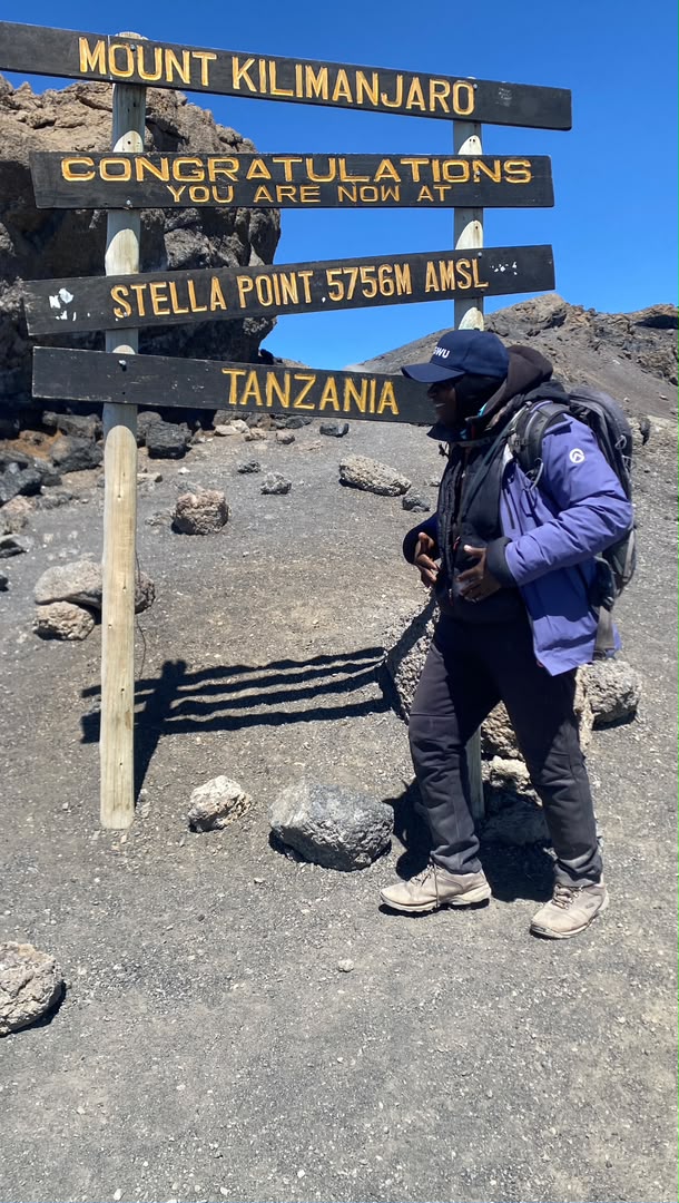 Senior Guide Sabinus Msimba leading a family expedition at Stella Point 5756m on Kilimanjaro during their summit night climb