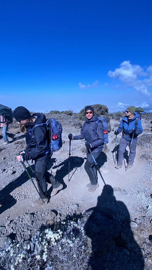 A mother with her son and daughter approaching Lava Tower, an acclimatization point on the Lemosho Route