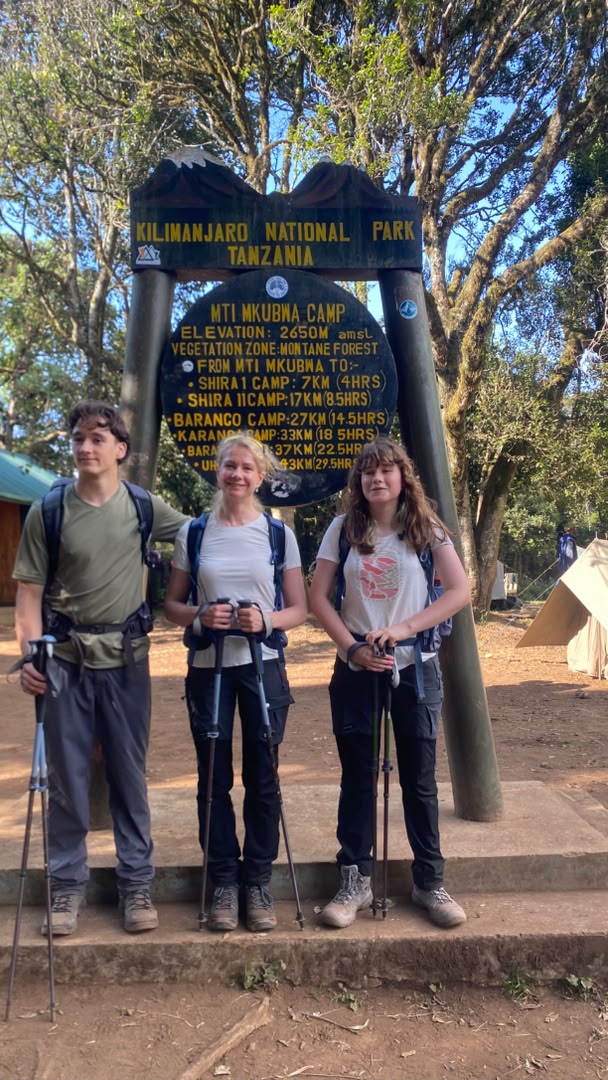 A mother with her son and daughter arriving at Mti Mkubwa Camp 2650m on Day 1 of their 8-day Lemosho Route family Kilimanjaro climb