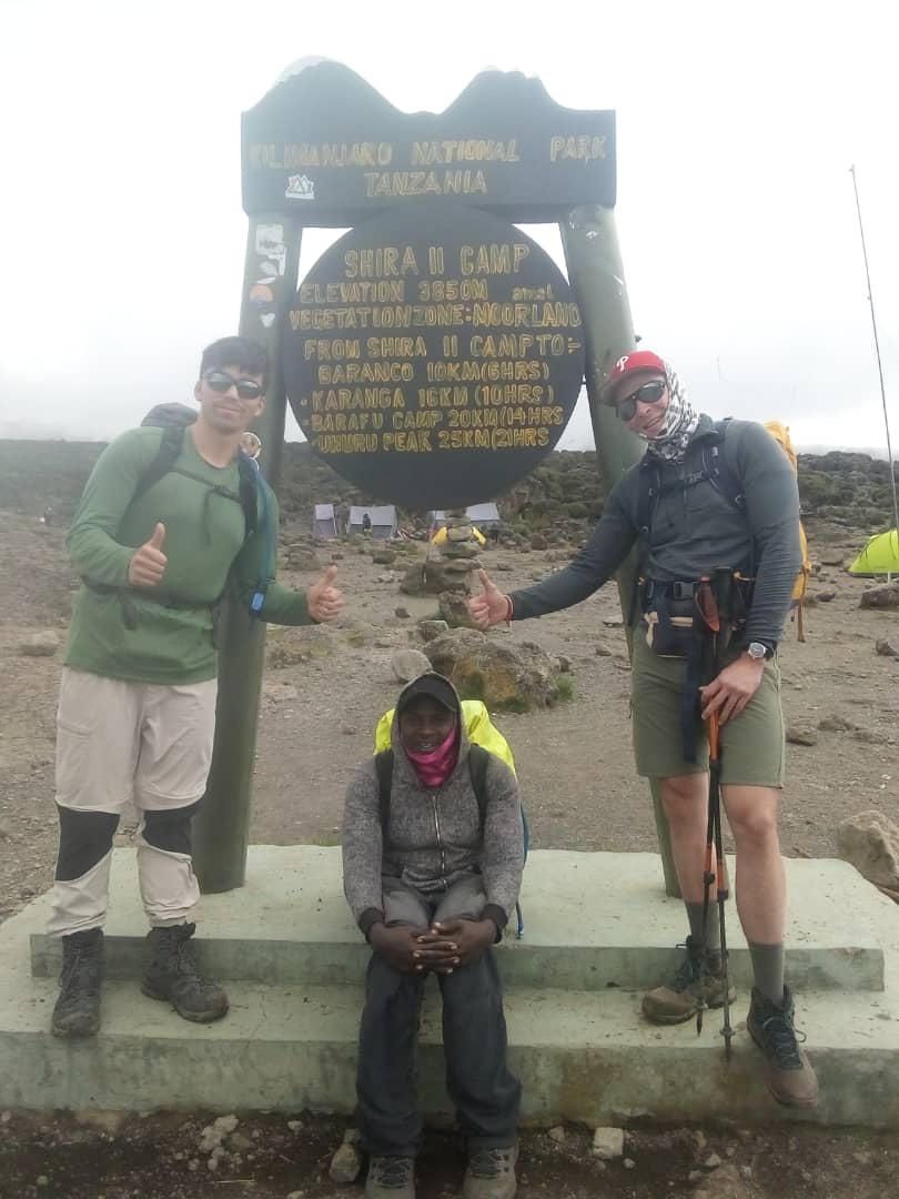 Sabinus Msimba with clients from France and USA at Shira 2 Camp