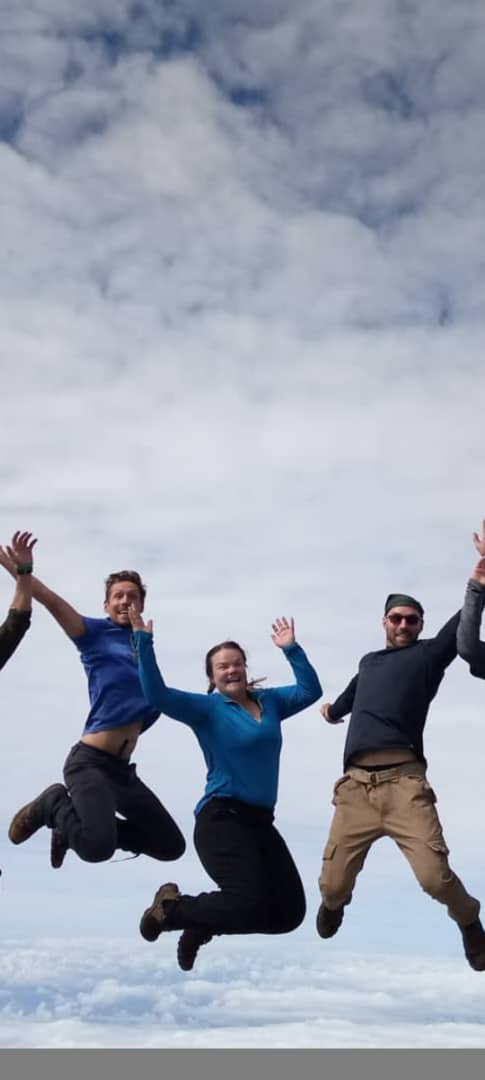 Climbers celebrate after completing the Barranco Wall on the Lemosho Route