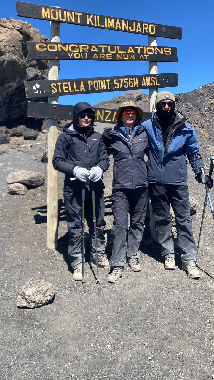 A mother with her son and daughter at Stella Point, 5,756m, on summit day of the 8-day Lemosho Route