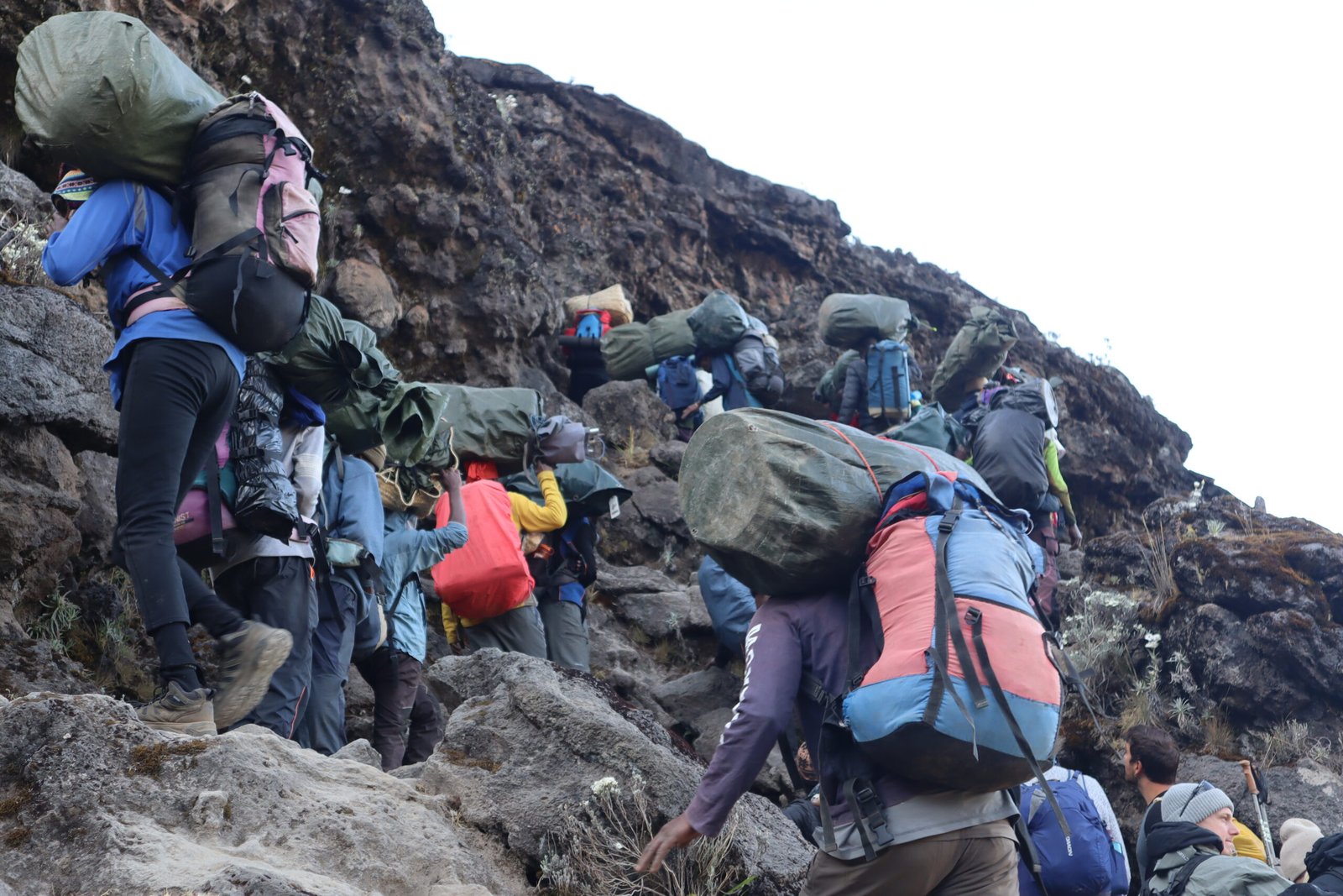 Successful summit celebration at Uhuru Peak on Kilimanjaro with guide Sabinus Msimba and climbing team
