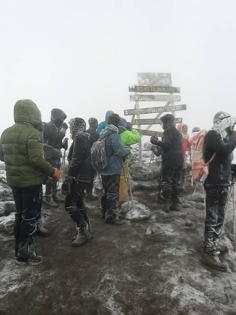 Climbers celebrate at Uhuru Peak, the highest point in Africa