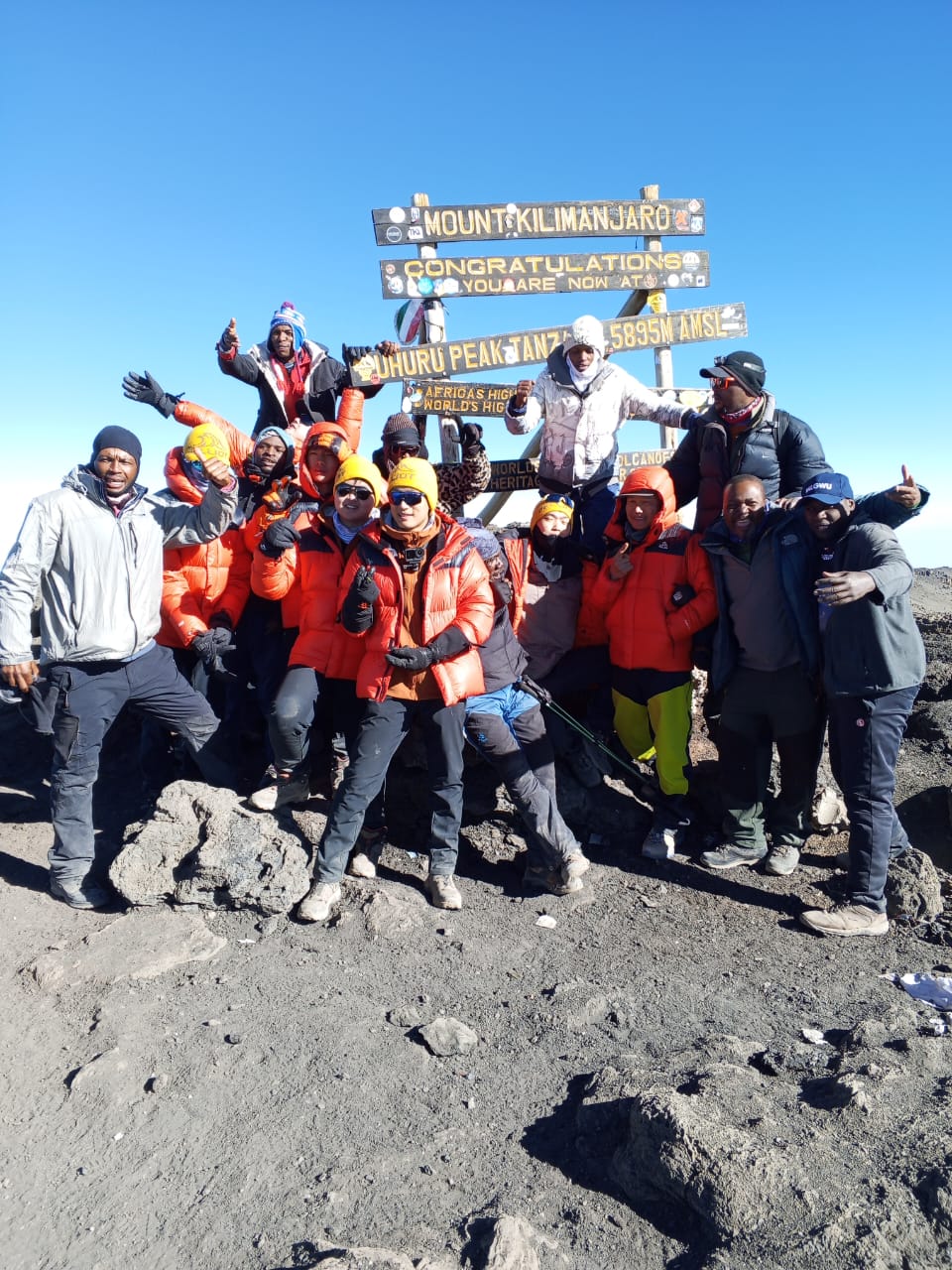 Climbers at Uhuru Peak on the 6-day Marangu Route