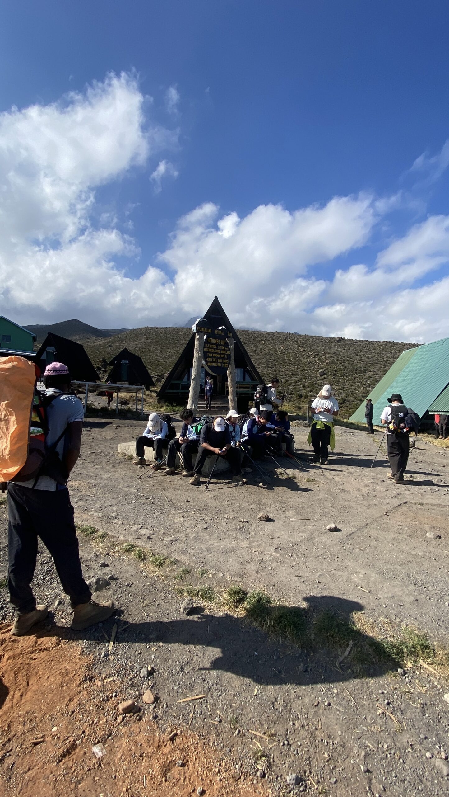 Climbers resting in the courtyard of the A-frame huts at Horombo Hut on the Marangu Route