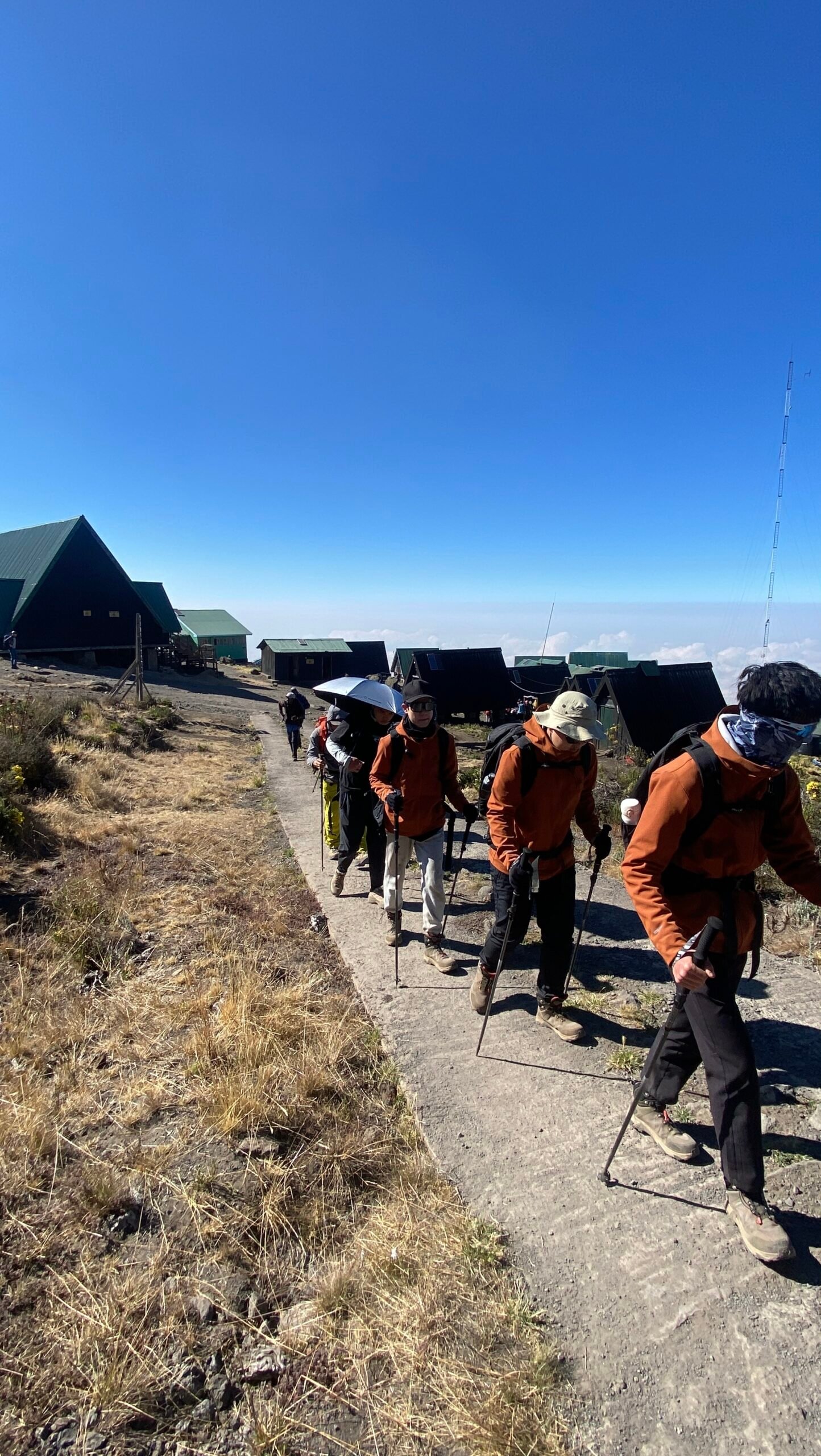 Climbers leaving Horombo Hut at 3,720 meters on the Marangu Route with clouds visible below