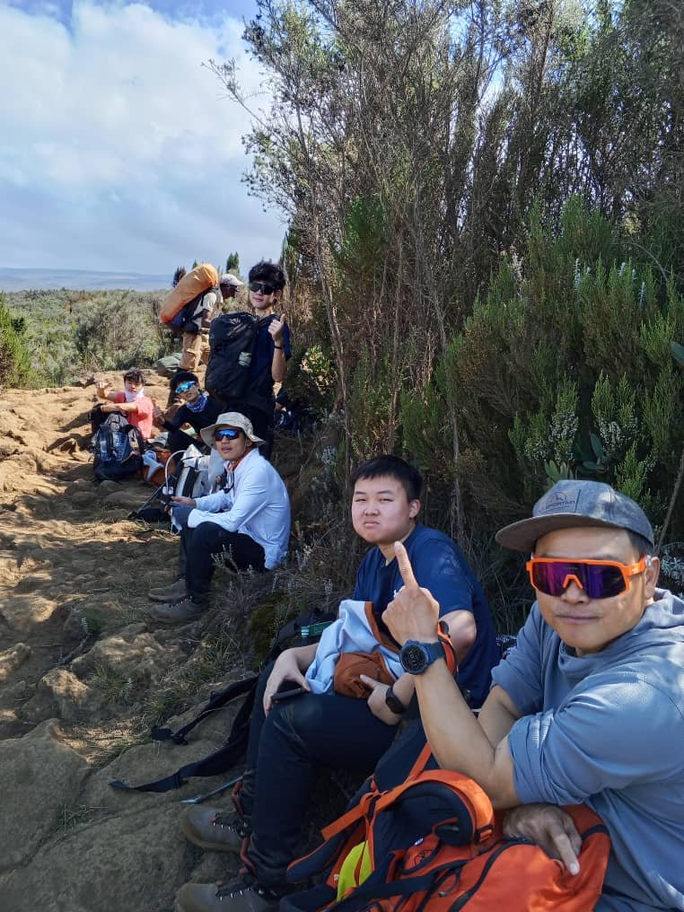 Kilimania climbing team resting at a moorland stop on the Marangu Route on Mount Kilimanjaro