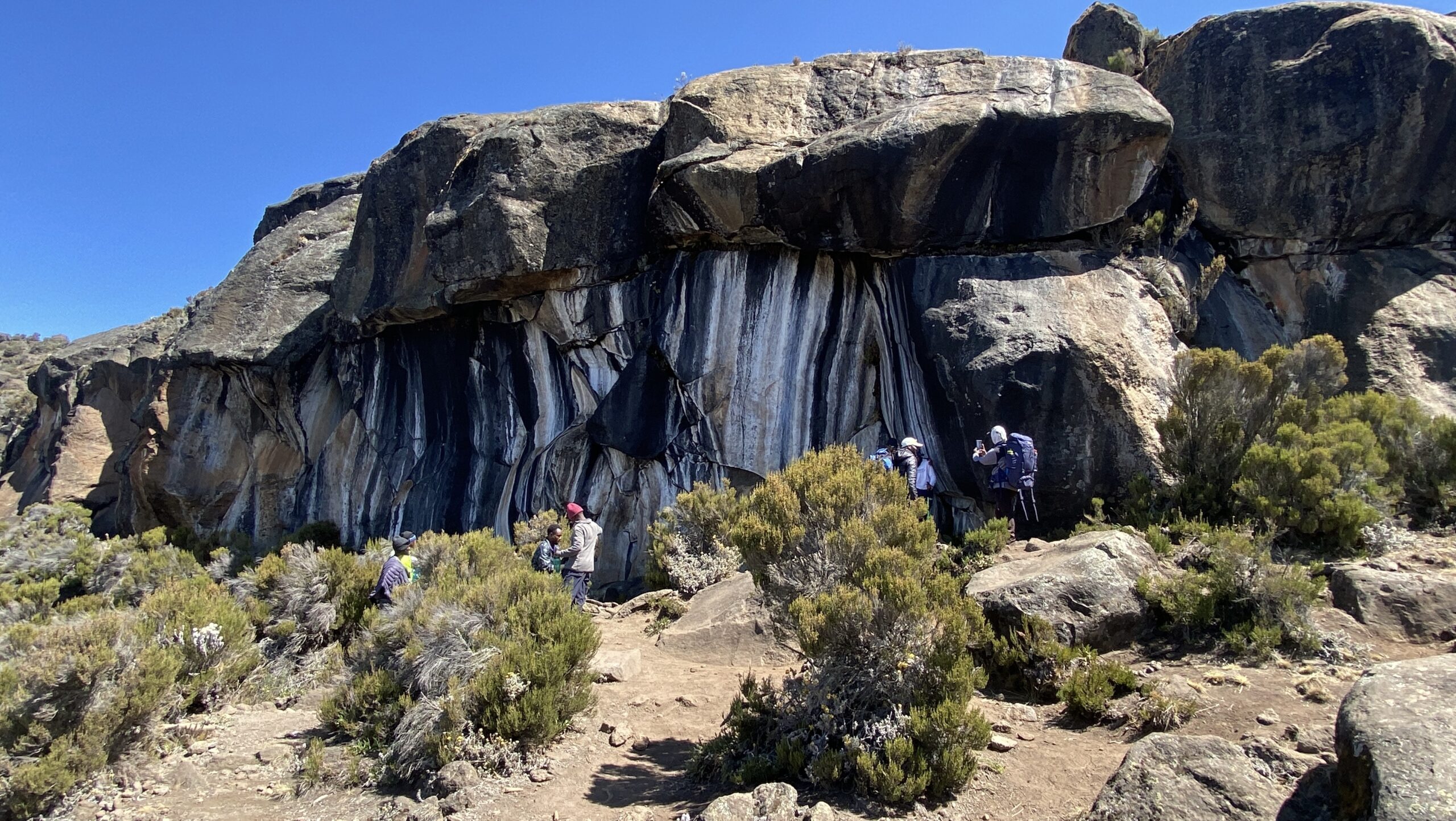 Guide checking on a climber's hydration and appetite near Zebra Rock