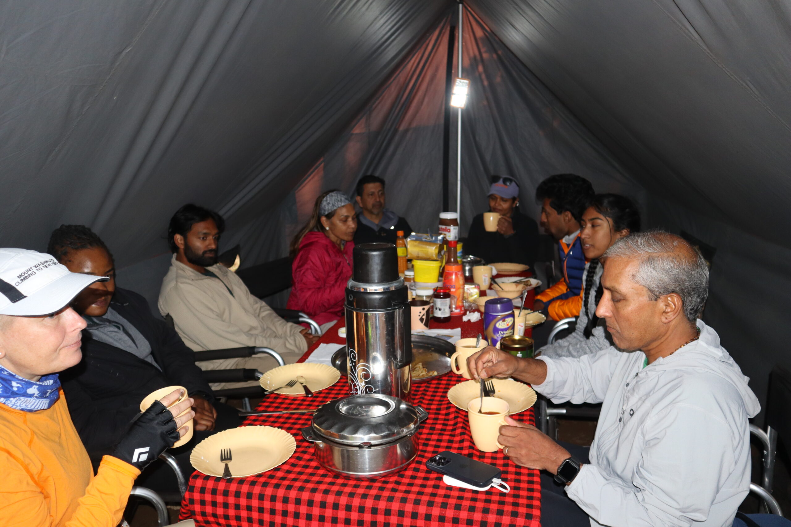 Climbers having evening tea after dinner at Shira One Camp on the Lemosho Route