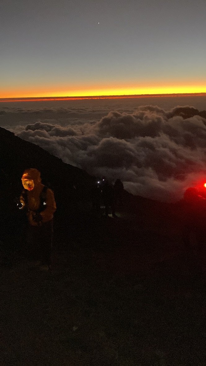 Climbers on the crater rim near Stella Point at sunrise during the Kilimanjaro summit night ascent