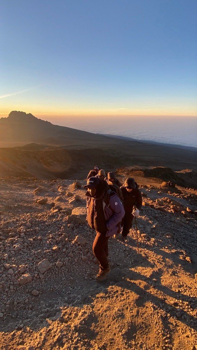 Senior Guide Sabinus Msimba leading a climbing group during the summit night ascent on Kilimanjaro in the section before Stella Point