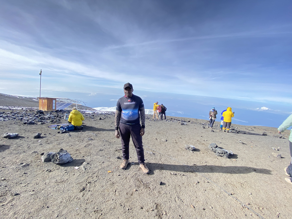 Kilimania guide with communication equipment on the upper mountain, separate from the TTCL network and mobile signal