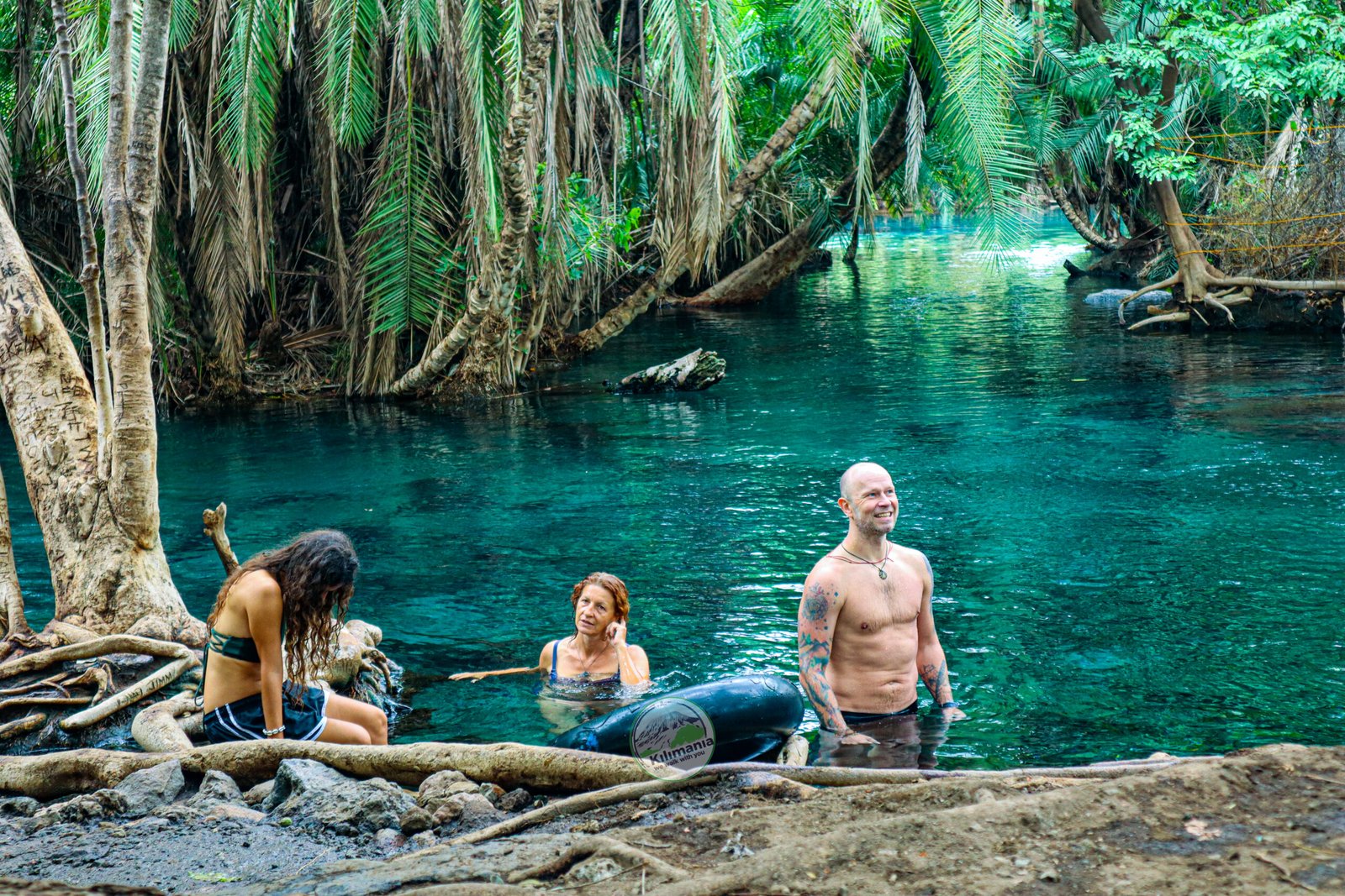 Kilimania clients swimming at Chemka Hot Springs the day after a Kilimanjaro descent