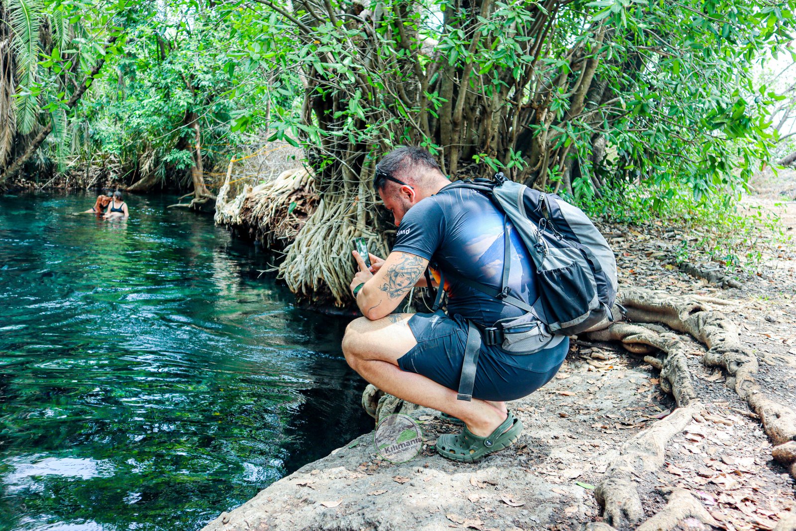 A Kilimania client photographing the clear spring water at Chemka Hot Springs