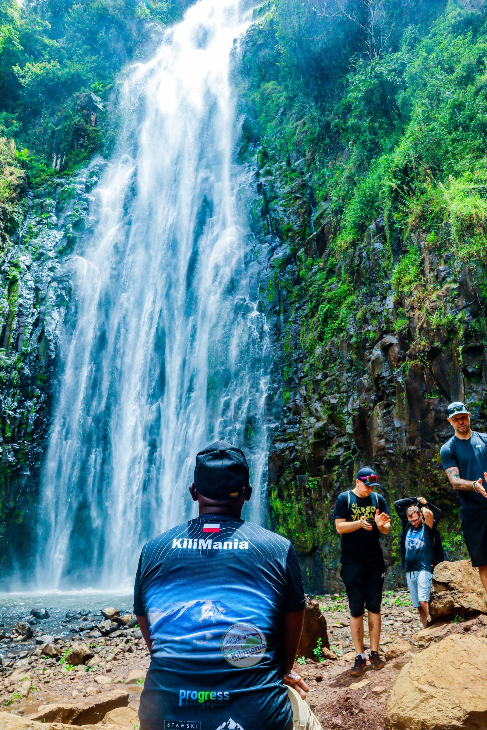 A Kilimania guide and clients at the base of Materuni Waterfall near Moshi