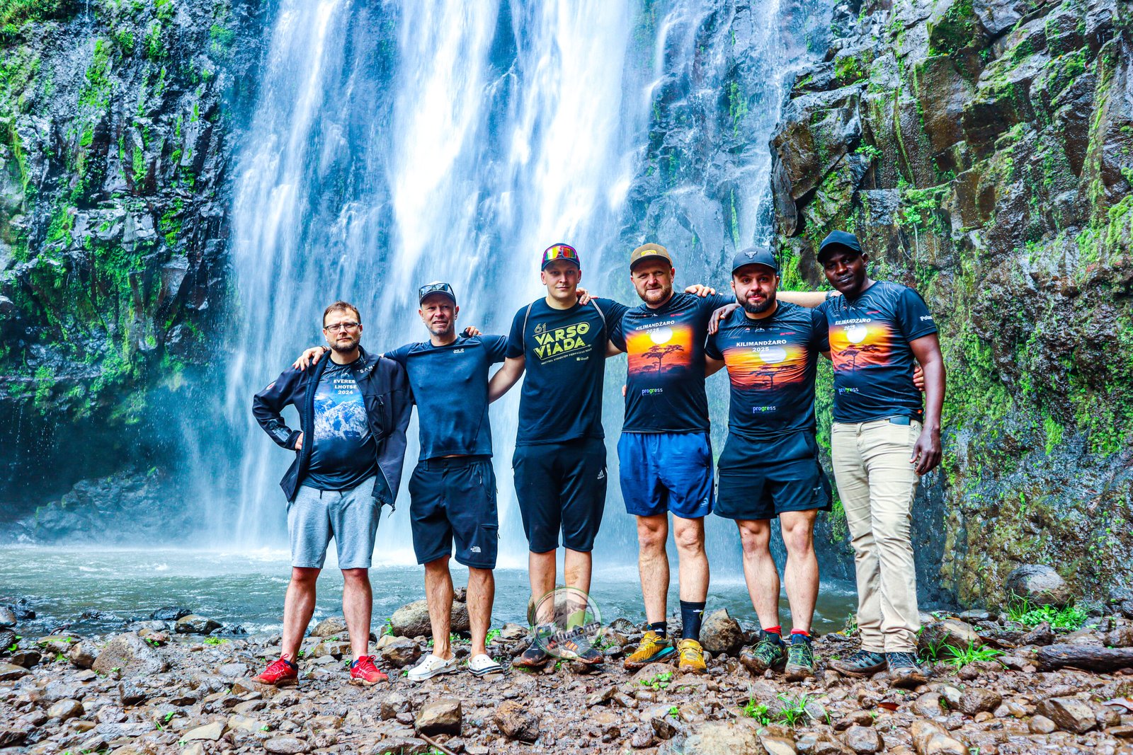 Sabinus Msimba with Kilimania clients at Materuni Waterfall during a day trip from Moshi, Tanzania