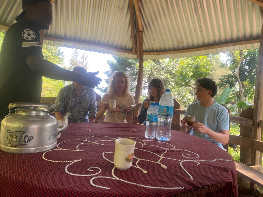 Coffee tasting under a shelter at Materuni Village with a local Chagga host