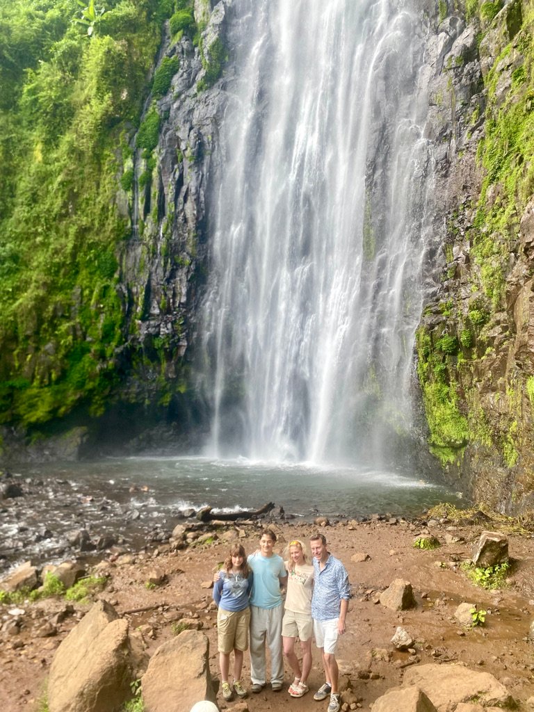 A family group of four at the base of Materuni Waterfalls near Moshi
