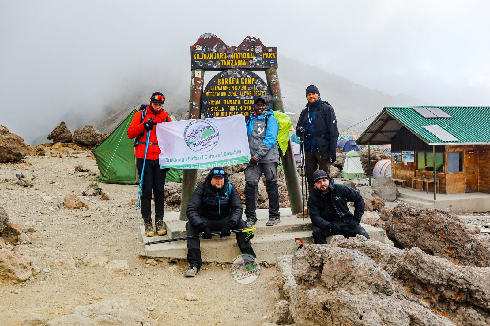 Sabinus Msimba with the Kilimania flag at Barafu Camp, summit base for the Lemosho and Machame routes