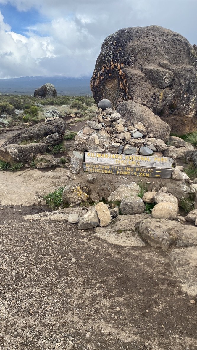 Cathedral Point sign on the Shira Plateau with Kibo peak visible behind